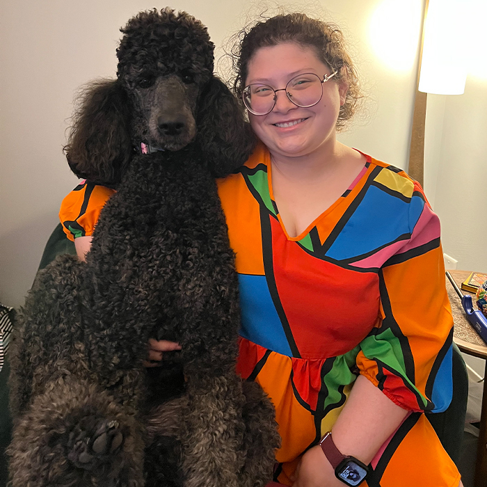 Reference photo of a woman and her poodle for a custom colored pencil portrait